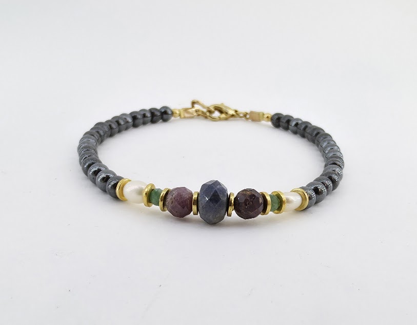 Pulseira de Hematita, Safira, Rubi, Esmeralda e Pérola Folheada a Ouro 18k – Joia Artesanal Exclusiva A Pulseira de hematita, safira, rubi, esmeralda e pérola folheada a ouro 18k é uma joia artesanal única, feita à mão pela Ceci Joias da Amazônia. Cada detalhe dessa semijoia delicada combina a força e o brilho de pedras naturais com o charme clássico das pérolas cultivadas em água doce, criando uma peça sofisticada, durável e exclusiva. Pulseira de Hematita, Safira, Rubi, Esmeralda e Pérola Folheada a Ouro 18k – Joia Artesanal Exclusiva A Pulseira de hematita, safira, rubi, esmeralda e pérola folheada a ouro 18k é uma joia artesanal única, feita à mão pela Ceci Joias da Amazônia. Cada detalhe dessa semijoia delicada combina a força e o brilho de pedras naturais com o charme clássico das pérolas cultivadas em água doce, criando uma peça sofisticada, durável e exclusiva.