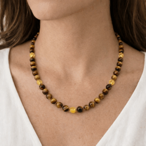 colar olho de tigre e citrino facetado banhados a ouro 18k. Colo da modelo.